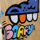 Graffiti of a toothed character and the word Sorry